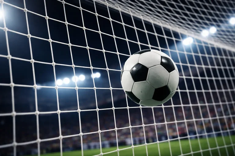 Fußball rollt ins Tornetz bei einem Abendspiel im Stadion